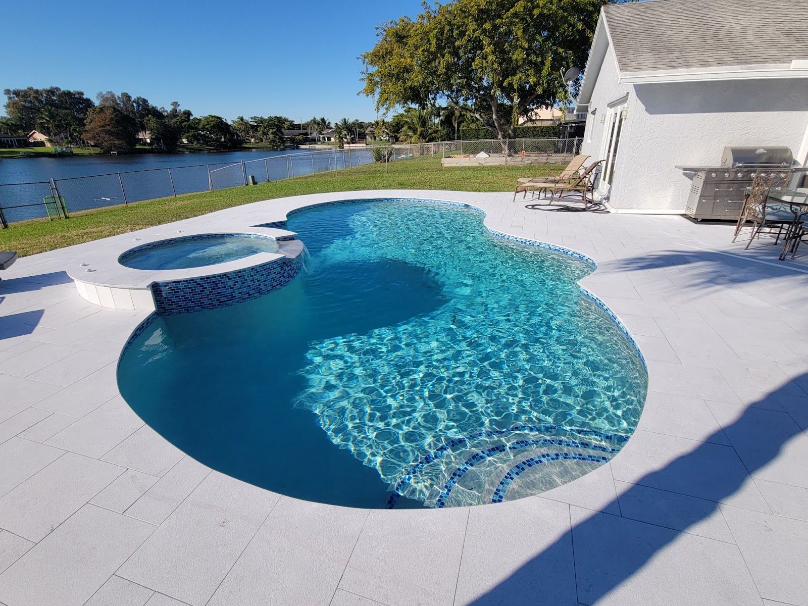 Poolside Renos lakefront pool renovation with spa
